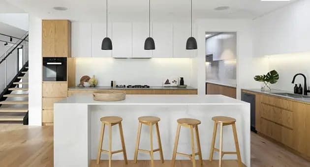 A modern kitchen with an open layout and central island, exemplifying an efficient working triangle design.