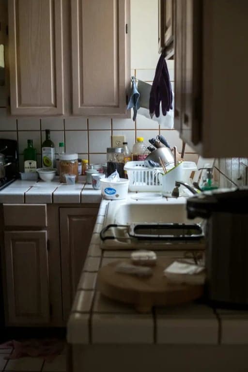 Before: A cluttered, inefficient kitchen layout. The refrigerator was stuck in a corner and the sink and stove were adjacent with no prep space, causing a cramped workflow and traffic jams.